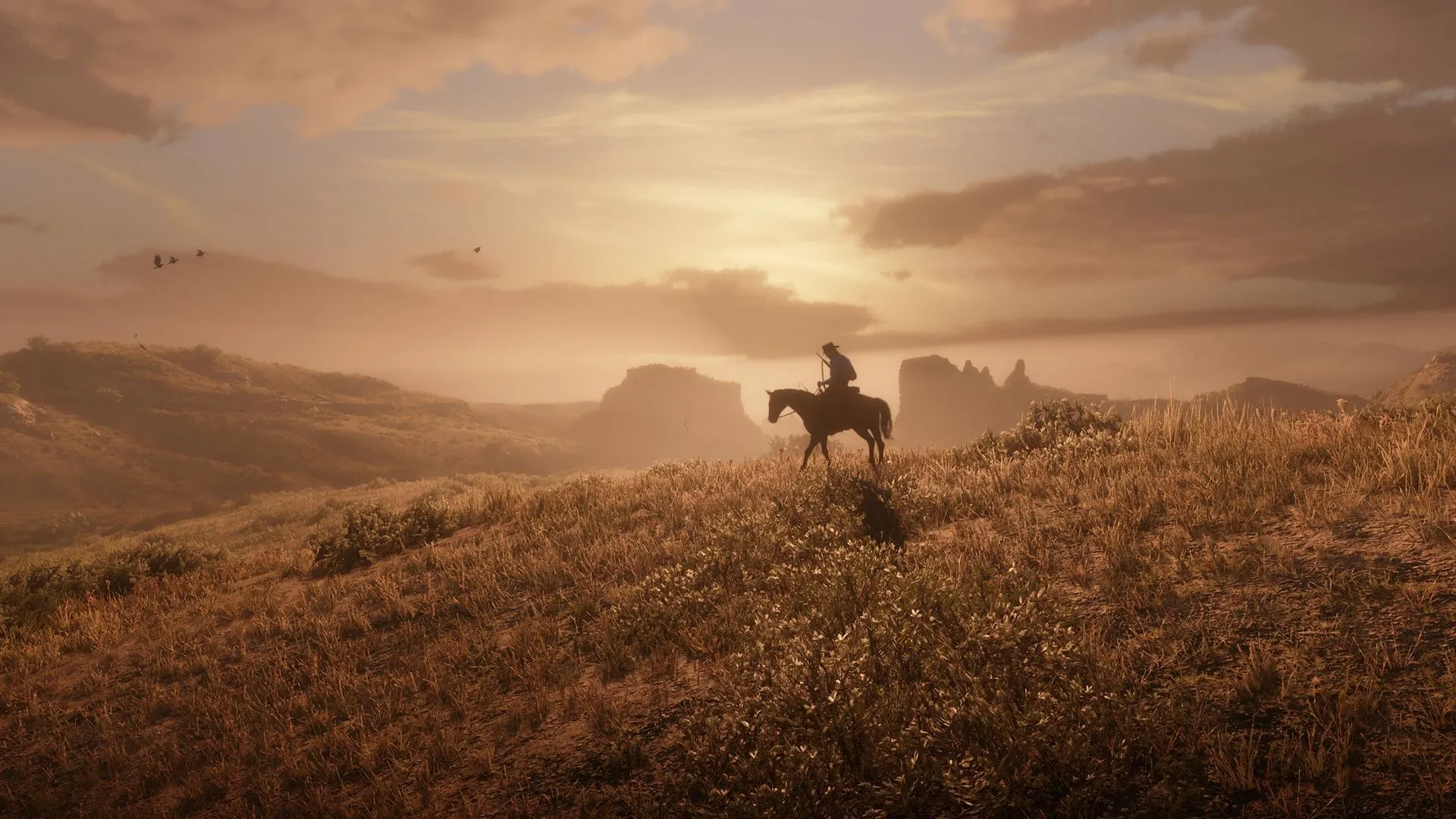 Cảnh hoàng hôn tuyệt đẹp trên một đồng bằng rộng lớn trong trò chơi Red Dead Redemption 2, với một người cưỡi ngựa nhỏ ở phía xa
