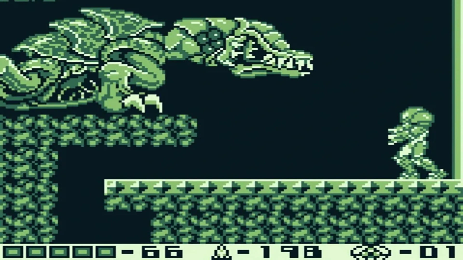 Hình ảnh gameplay từ Metroid II: Return of Samus trên Game Boy, với Samus Aran trong bộ Power Suit đang bắn kẻ thù trong môi trường đơn sắc