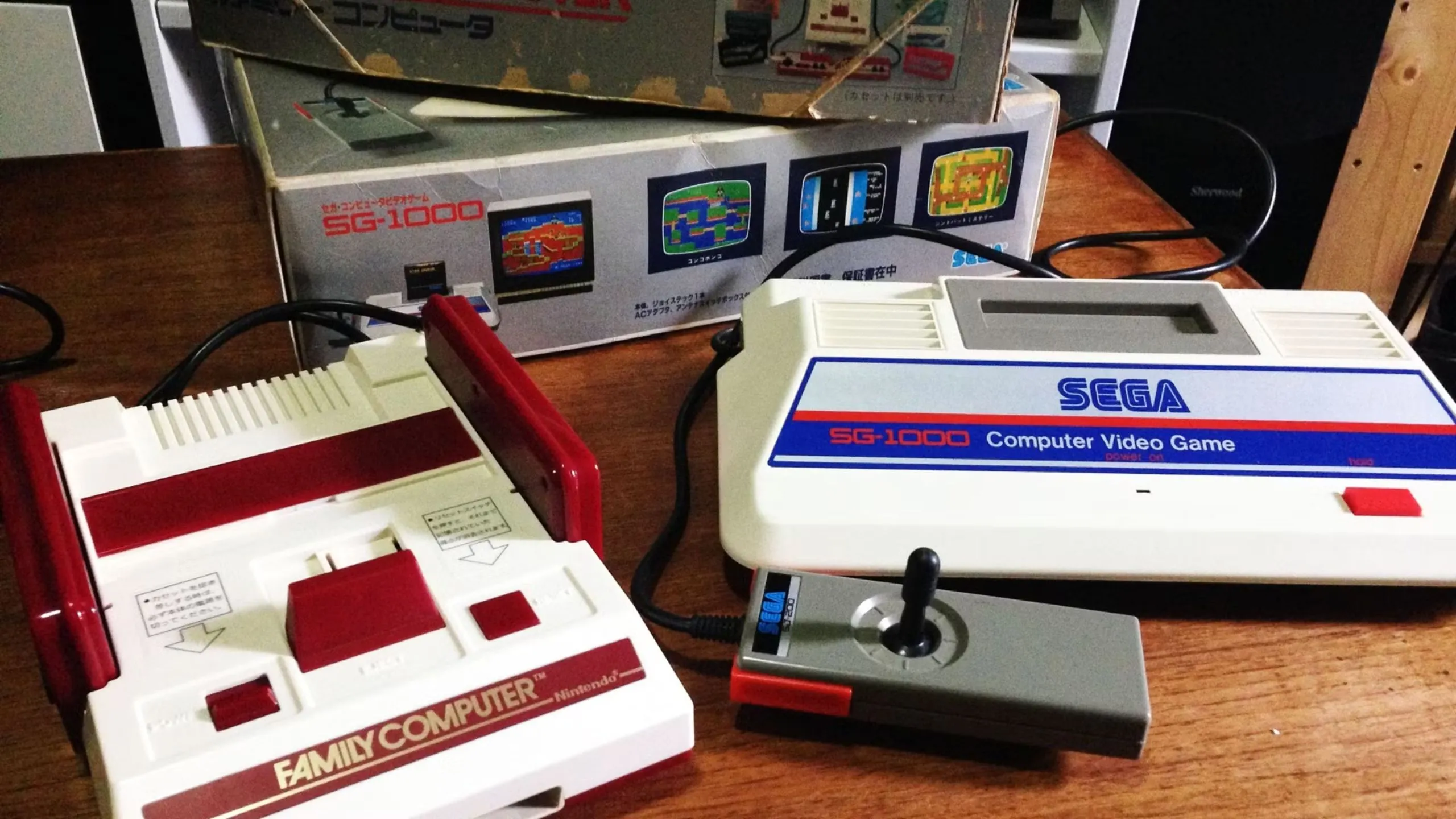 Hình ảnh máy chơi game Sega SG-1000 và Famicom đặt cạnh nhau