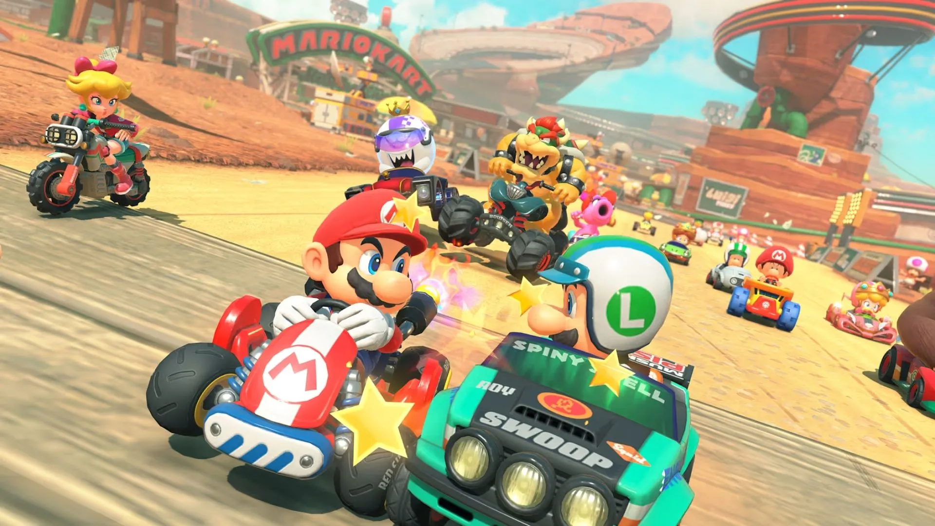 Nhân vật Toadette điều khiển xe đua trên một đường đua sắc màu trong Mario Kart World